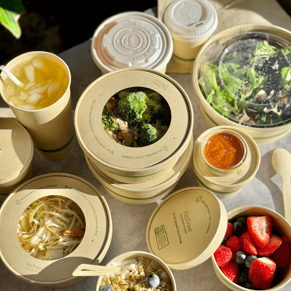 multiple sustinable food packaging containers on table